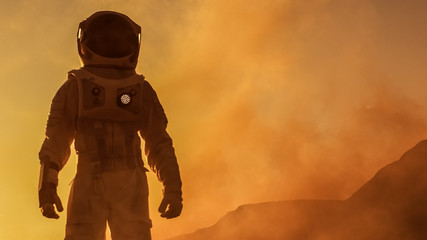 Wall Mural - brave astronaut confidently walks on mars surface. red planet covered in gas and rock, overcoming di