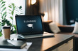 © foxyburrow - Close up of laptop with inscription on screen e-learning and image of square academic cap and smartphone on table in empty room.