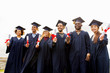 © Syda Productions - happy students in mortar boards with diplomas