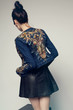 © EVGENY FREEONE - Young beautiful woman posing in studio wearing jeans jacket and leather skirt