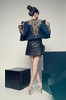 © EVGENY FREEONE - Young beautiful woman posing in studio wearing jeans jacket and leather skirt