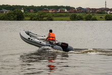 Man Riding In An Inflatable Boat With A Motor On Sea