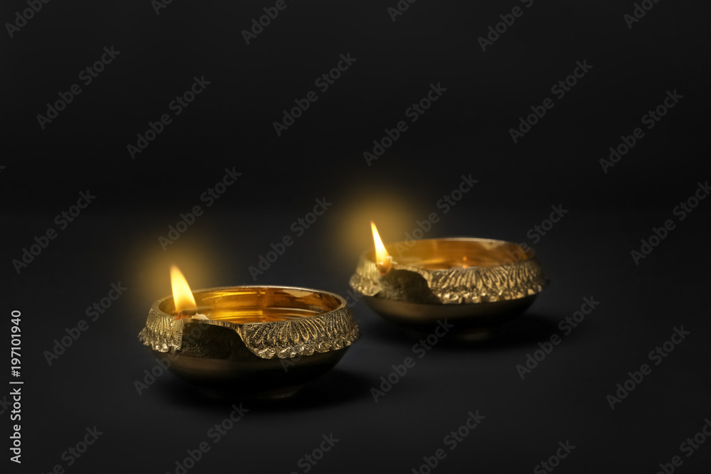Diwali diyas or clay lamps on dark background