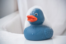 Closeup Of Blue  Rubber Duck Toy With Moss On Bath