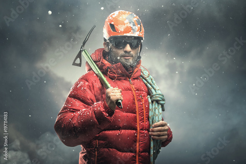 Fotomural Climber reaching the summit. Snow storm.