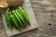 pile of raw okra on sack cloth with old and crack wooden surface background. organic healthy food concept.
