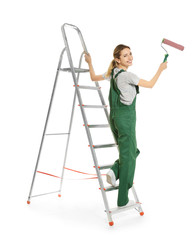 Canvas Print - Young female decorator with paint roller on white background