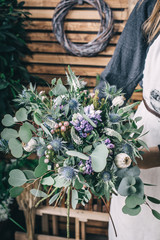 Poster - Florist working in modern flower shop. Young woman entrepreneur with her own business.