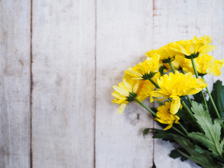 Wall Mural - yellow chrysanthemums flowers on vintage white wood.