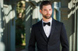 Stylish attractive and masculine groom standing alone, well dressed, modern and sleek