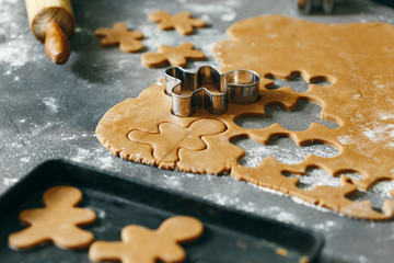 Sticker - Sheet of raw dough with form for cutting cookies. Ingredients for cooking Christmas gingerbread cookies close up