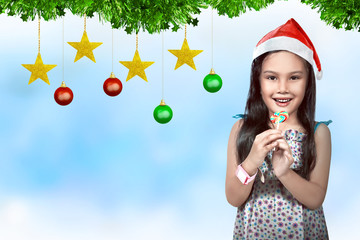 Wall Mural - Cute asian little girl wearing santa hat with christmas decoration