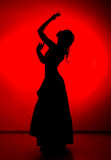 Fototapeta Sypialnia - silhouette of spanish girl flamenco dancer on a red background