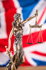 Wall Mural - Lady Justice and United Kingdom flag. Symbol of law and justice with UK Flag