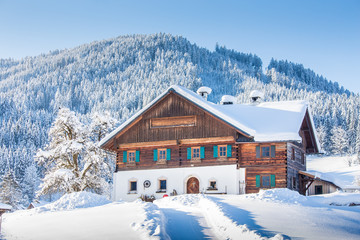 Wall Mural - traditional farmhouse in winter wonderland in the alps