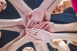 © My Ocean studio - Close up photo of young smiling women putting their hands together. Friends with stack of hands showing unity and teamwork.