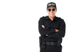 © LIGHTFIELD STUDIOS - Smiling policeman wearing uniform with arms folded isolated on white