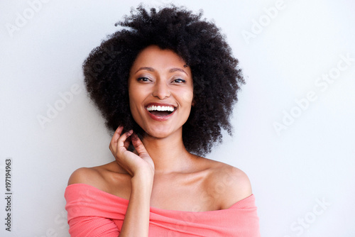 Close Up Young African Woman With Curly Hair Smiling Against White