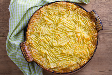 Wall Mural - Shepherd pie - popular dish in Ireland. Beef meat, mashed potato, cheese, carrot, onion and green peas casserole in baking dish. View from above, top