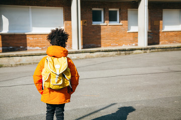 Little school boy at the entrance of school