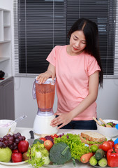 Sticker - woman making vegetable smoothies with blender in kitchen