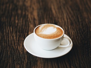 close up coffee latte art on wooden table.