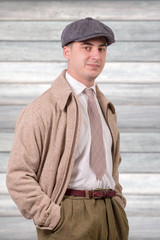 Wall Mural - young man in vintage clothes with hat, 1940 style