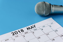 Calendar And Microphone On Blue Background