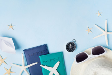 Summer holidays, vacation, travel and tourism background from sunglasses, hat, passport, airplane and boat miniatures, starfish. Top view. Flat lay style.