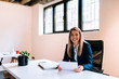 © bnenin - Successful business concept. Smiling blonde business woman sitting at the bright office. Looking at camera.