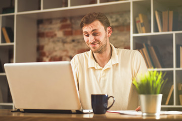 Canvas Print - Young man with a laptop