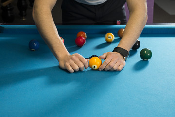 Wall Mural - A billiard player assembling balls for a match of 9 ball tournament.