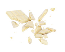 White Porous Chocolate Broken Into Pieces In The Air, Isolated On A White Background