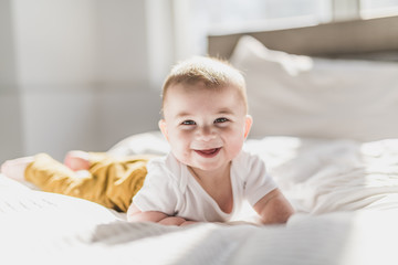 Wall Mural - Portrait of a baby boy on the bed in bedroom