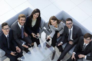 Wall Mural - Top view of beautiful young business  people in using smartphone