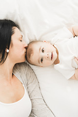 Wall Mural - Mother with a baby on bed at home