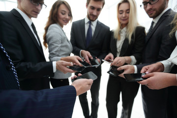 Wall Mural - close-up of smartphones in the hands of business youth