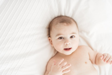 Wall Mural - Portrait of a baby boy on the bed in bedroom