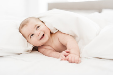 Wall Mural - Portrait of a baby boy on the bed in bedroom