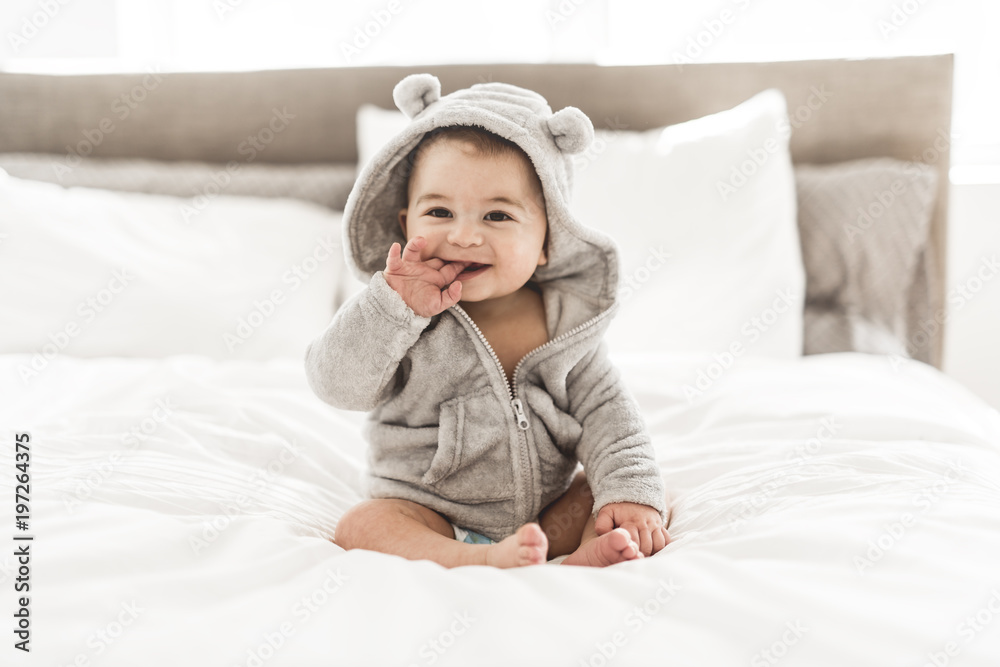 Portrait of a baby boy on the bed in bedroom - obrazy, fototapety, plakaty 