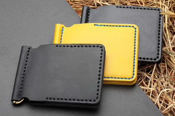 Set of three yellow and and black card holder. Hand made leather man card holder. Multi colored. Leather craft.On cretive background .Top view