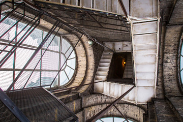 Poster - Metal spiral staircase in the tower. The stairs to the top. Staircase with large windows.
