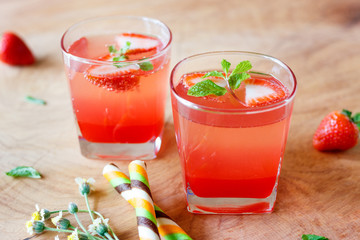 Summer strawberry drink on wooden table.