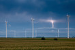 Wind turbines with a lightning bolt on the background