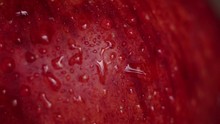 Close-up Of Splashing Water On A Red Apple. Close-up Shot. Red Wet Apple With Big Droplet, Macro Shot.