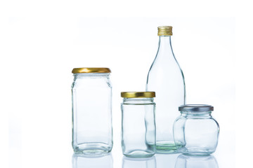  Clear glass bottles in various sizes and shapes with lids on white background