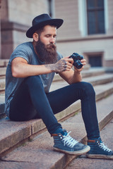 Wall Mural - A handsome hipster male with a stylish beard and tattoo on his a