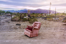 Old Armchair In Salton City, California, United States. American Ghost Town At Sunset.