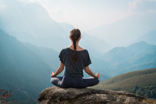 Woman Meditates In Yoga Asana Padmasana
