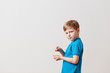 © Alyona - the boy eats a candied pineapple on white background